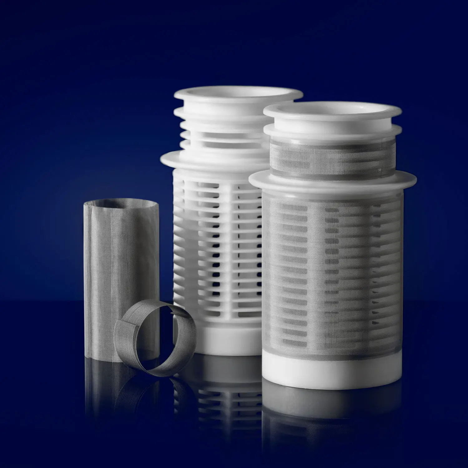 Plastic and stainless steel mesh filters on a navy backdrop
